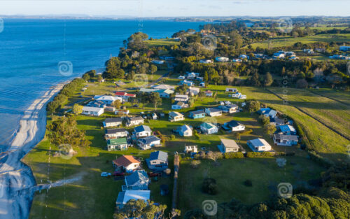 Aerial View of Grahams Beach close to the park, Green Trees and Cliff in New Zealand – Auckland Area - NZ Stock Photos